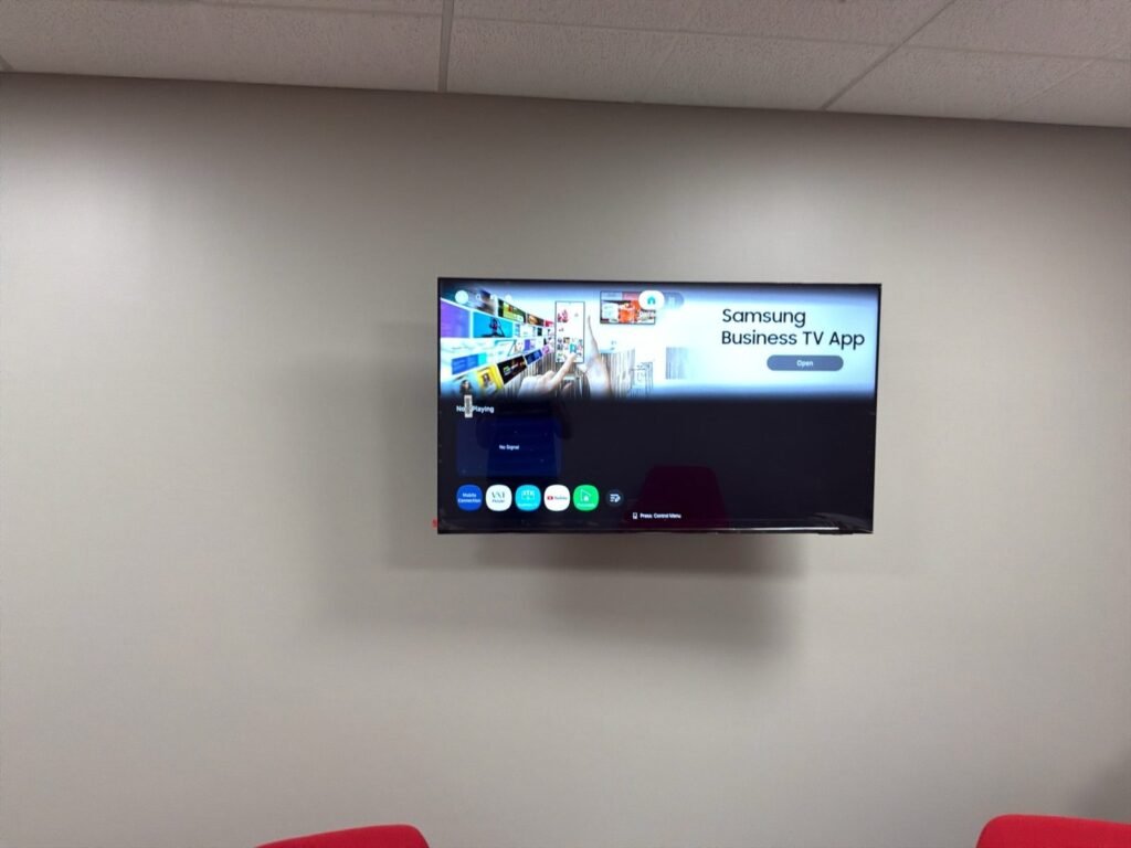 Commercial TV mounted on a conference room wall
