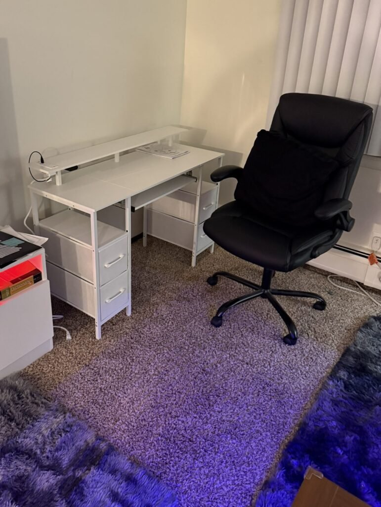Assembled white desk with drawers and an office chair