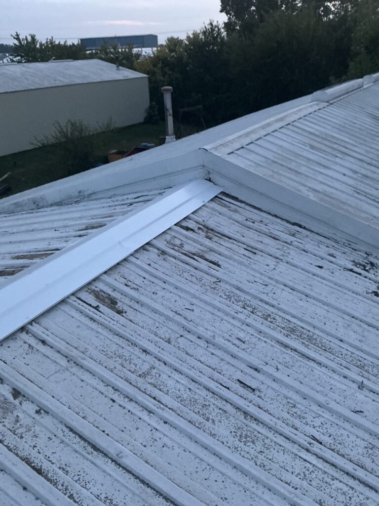 New metal flashing installed on a commercial metal roof