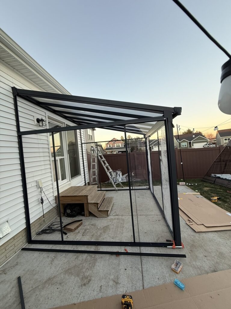 Porch enclosure kit frame being assembled on a patio