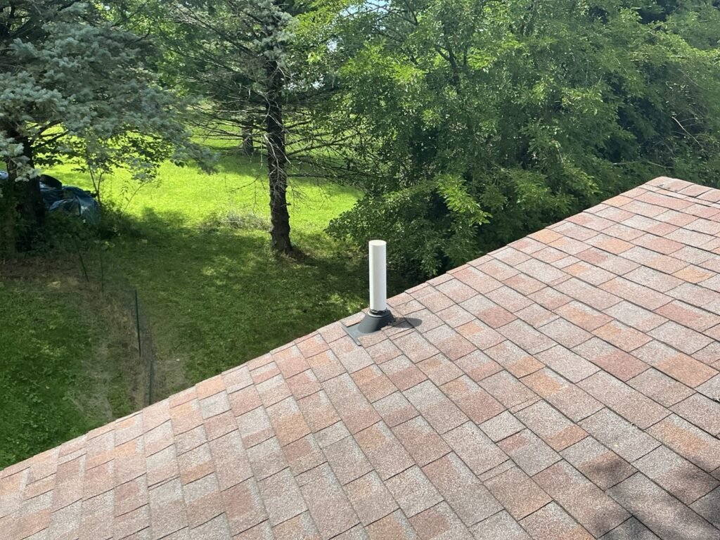 Asphalt shingle roof with a plumbing vent